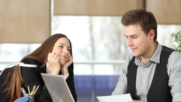 Candid young businesswoman falling in love with a colleague at office