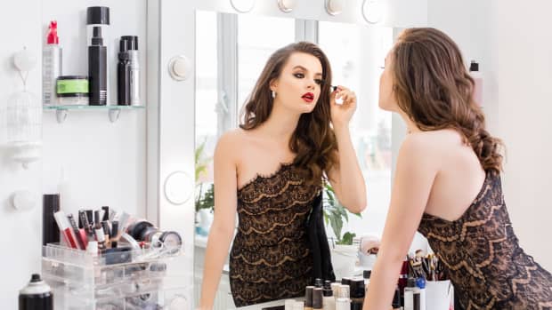 young sexy beautiful sexy woman doing make-up at mirror, night dress, red lipstick, mascara
