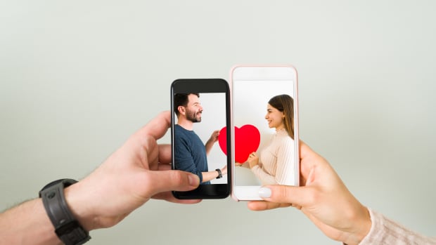 two people holding a dating app