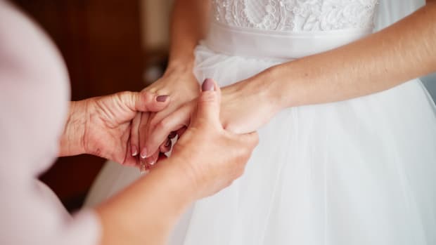 mom holds the bride's hands